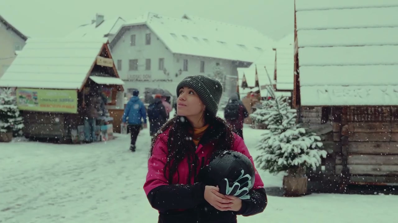 Smiling Woman Catching Snowflakes in Snowfall