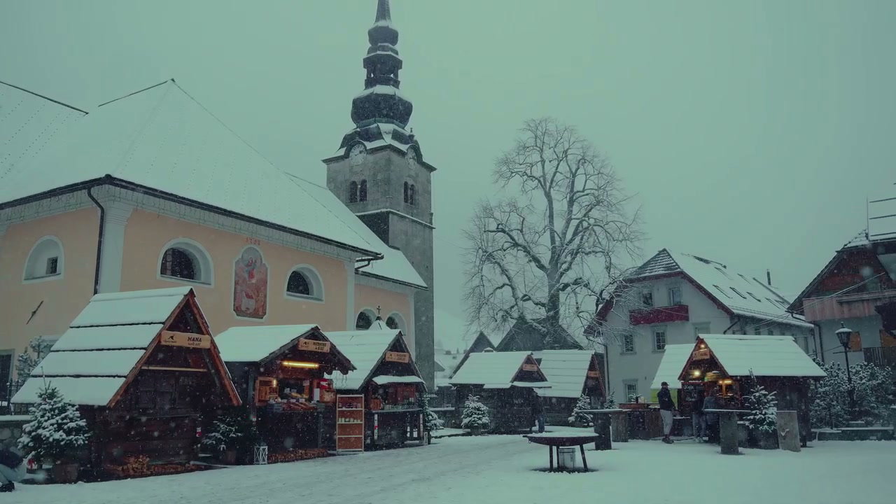 Winter Christmas Market with Snowfall and Church