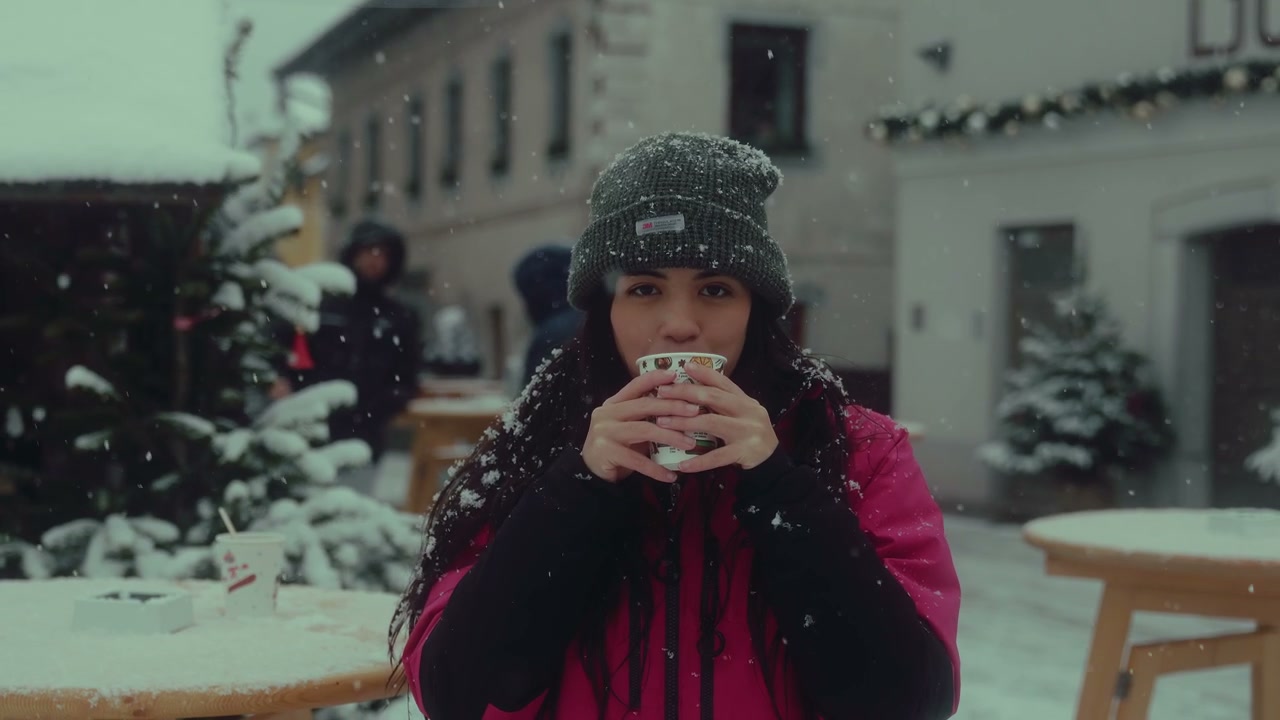 Young Woman Drinking Hot Chocolate in Snow