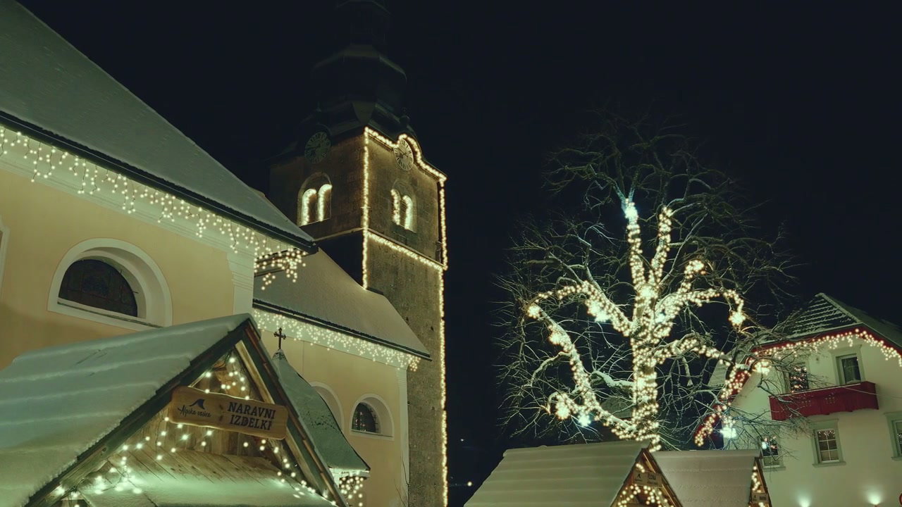 Christmas Lights Decorate Village Church at Night