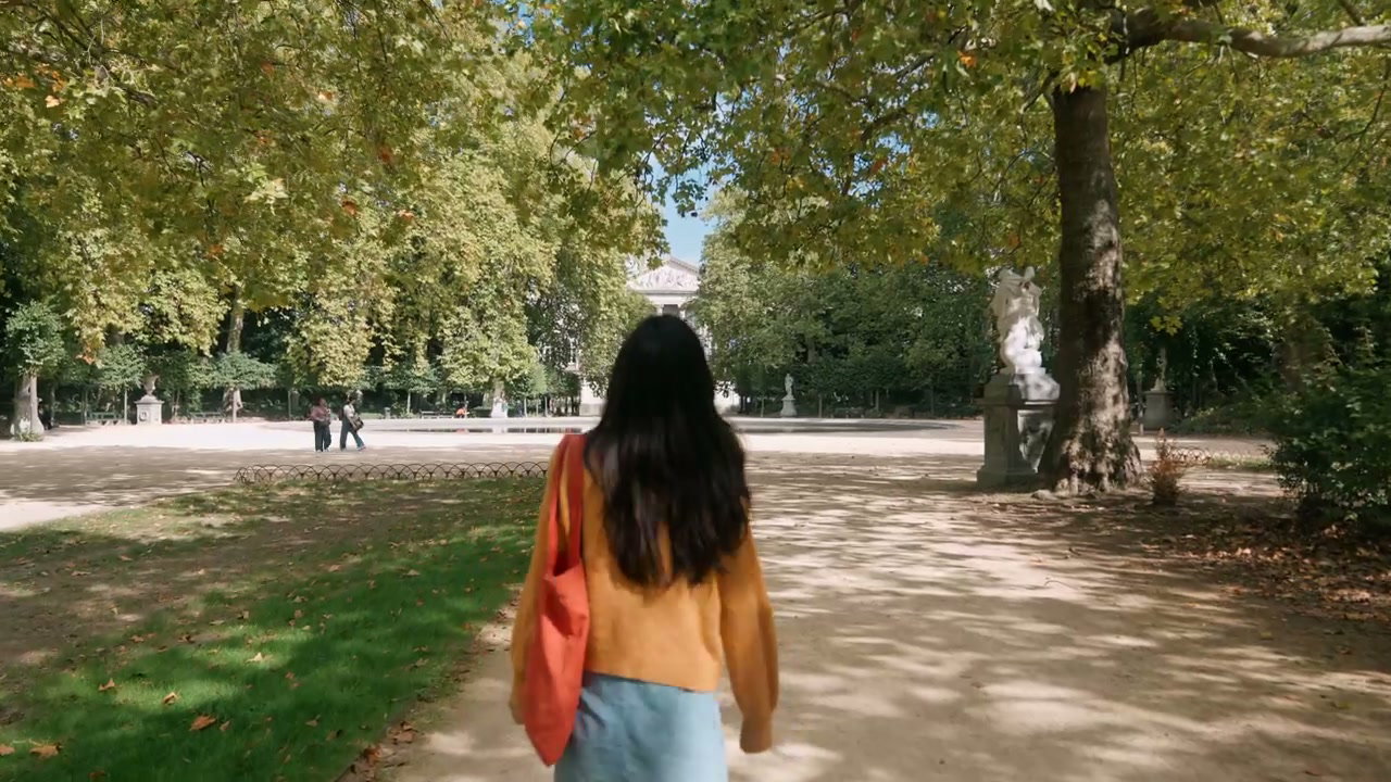 Woman Walking Through City Park in Brussels