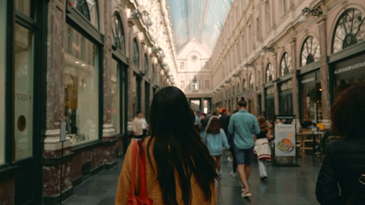 Young Woman Walking in Brussels Shopping Arcade