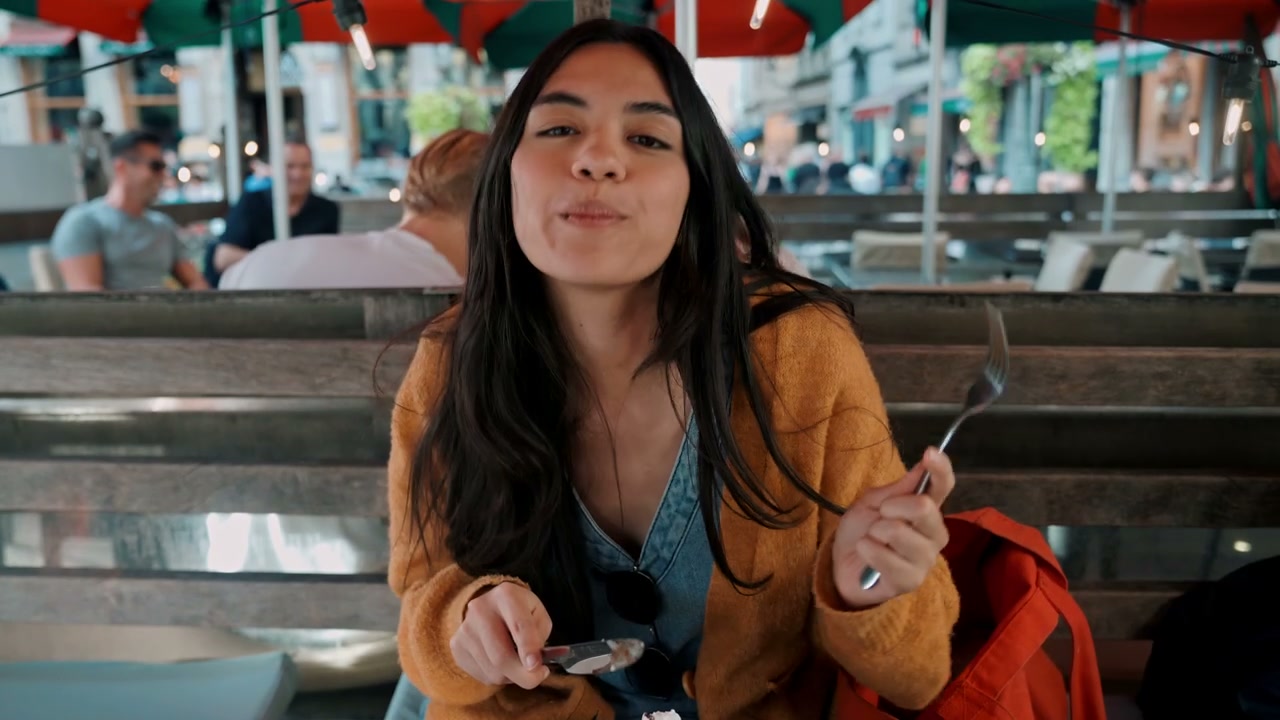 Young Woman Eating Waffles in Brussels