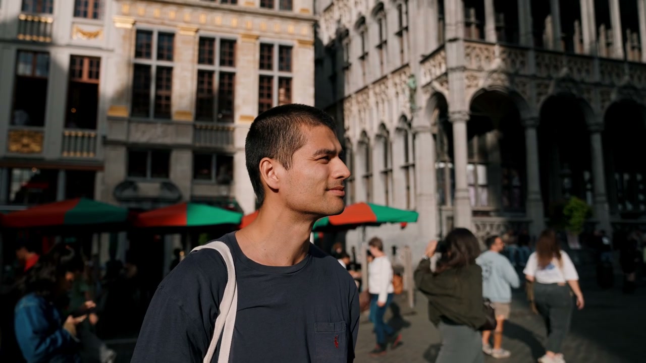 Young Man Looks Around Brussels City Square