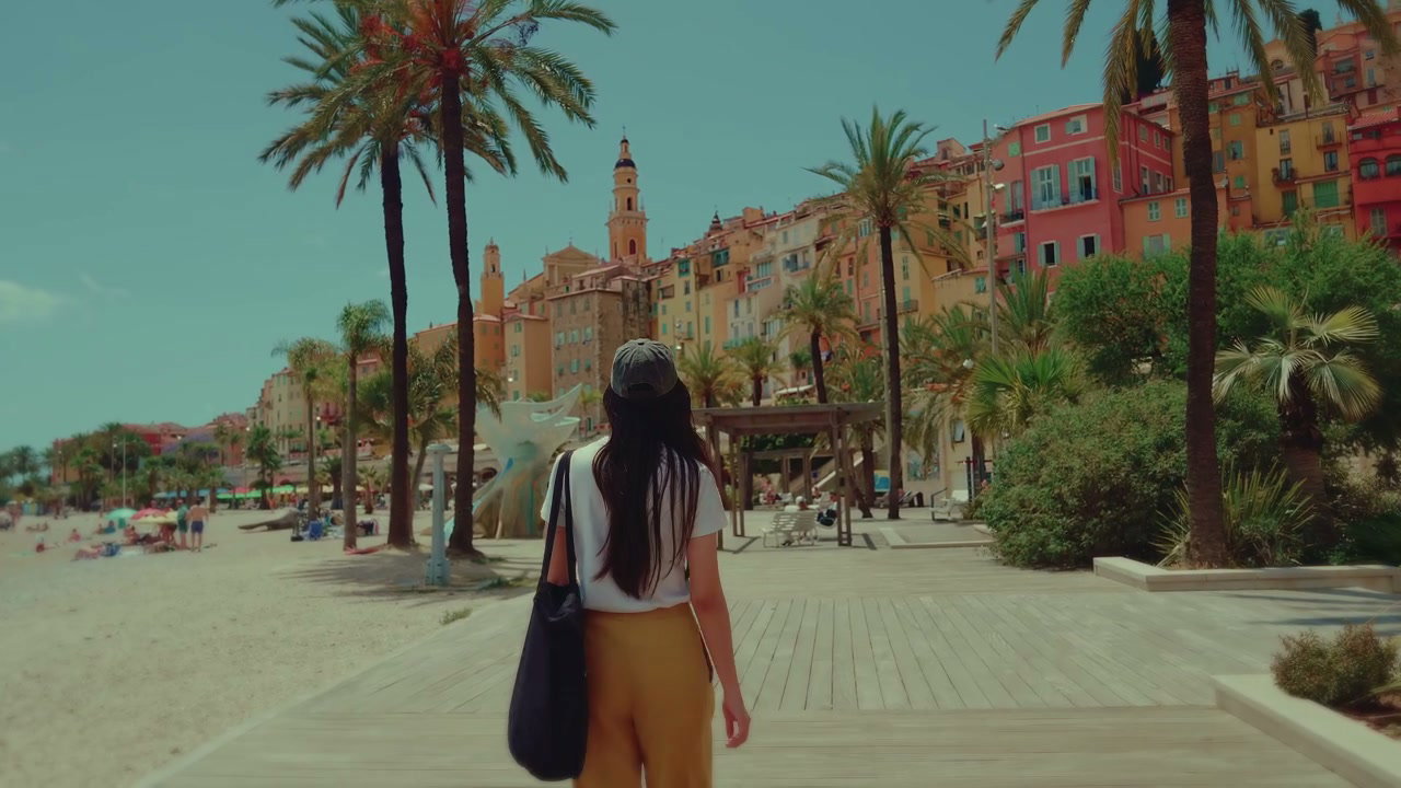 Woman Walking Along Menton Beach Promenade