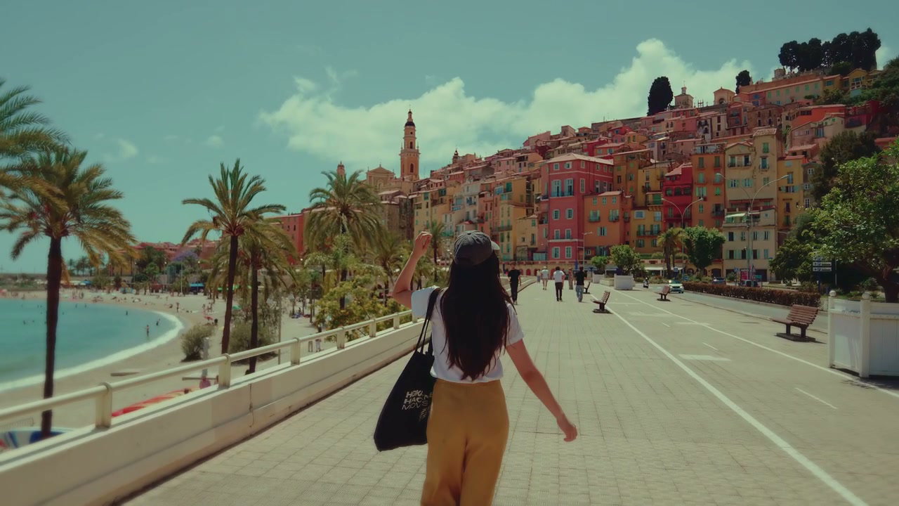 Woman Walking on Menton Promenade