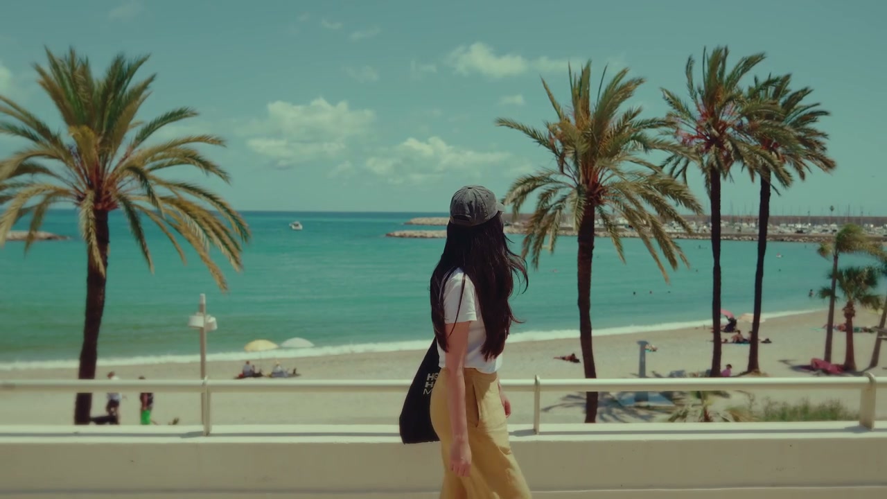 Woman Walking by Beach Promenade in Menton