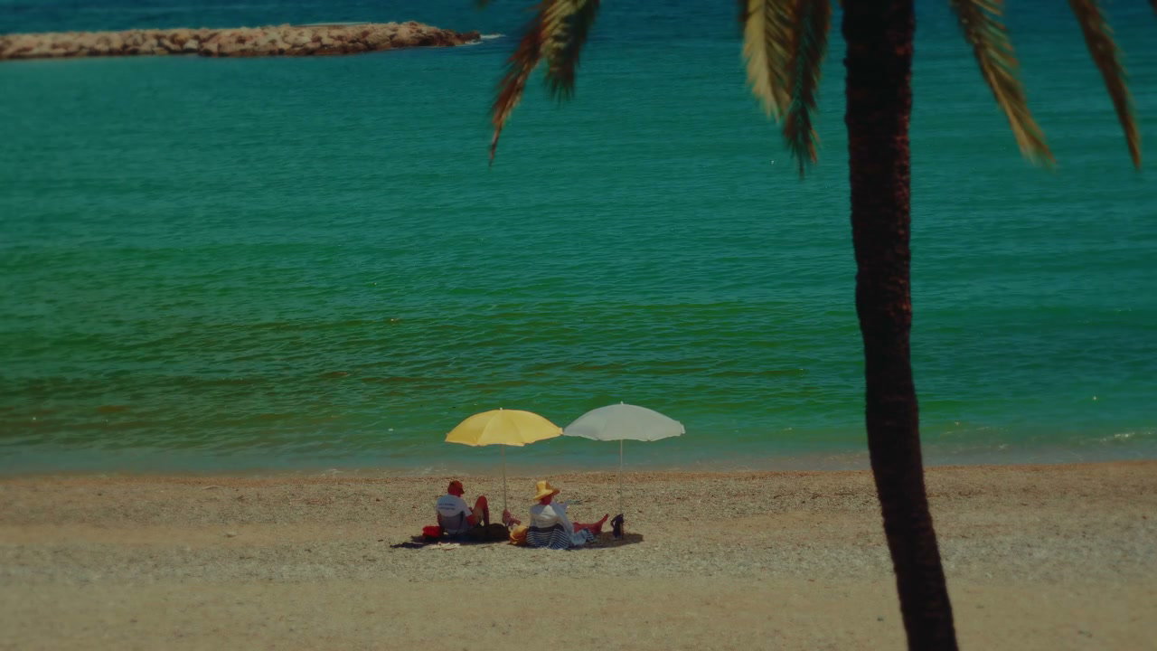 People Under Beach Umbrellas on Sunny Coast