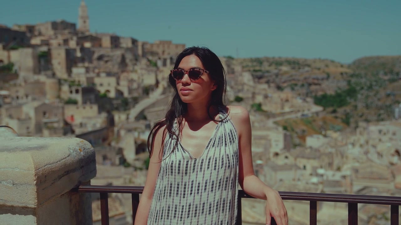 Young Woman Overlooking Matera Cityscape