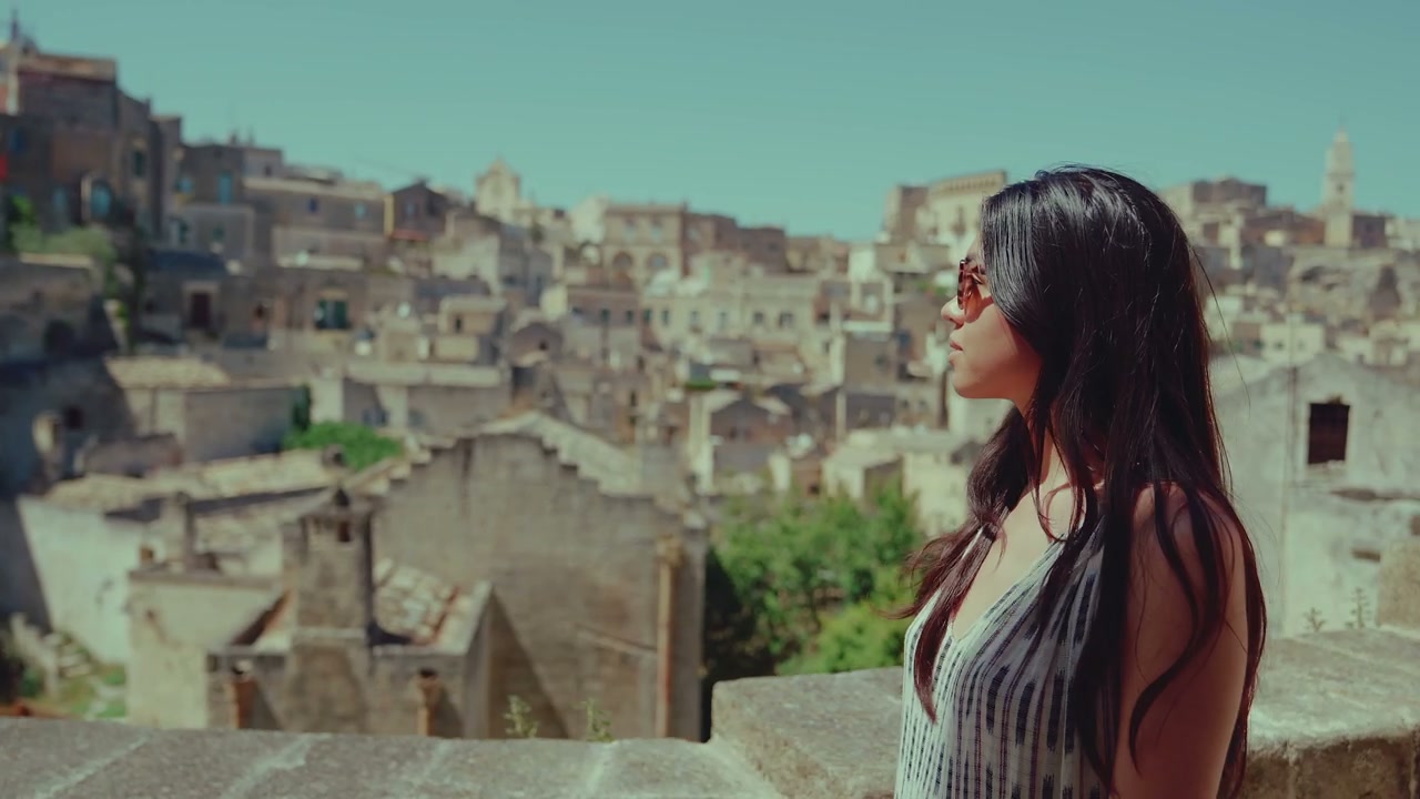 Woman Explores Ancient Matera Cityscape