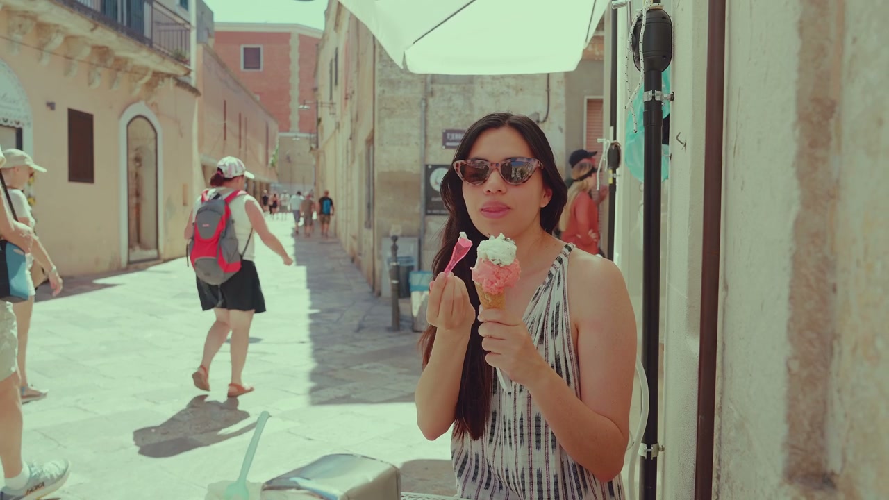 Woman Enjoying Gelato in Matera Street