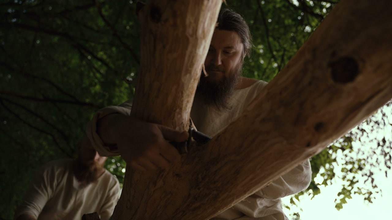 Historical Men Debarking a Tree Log Outdoors