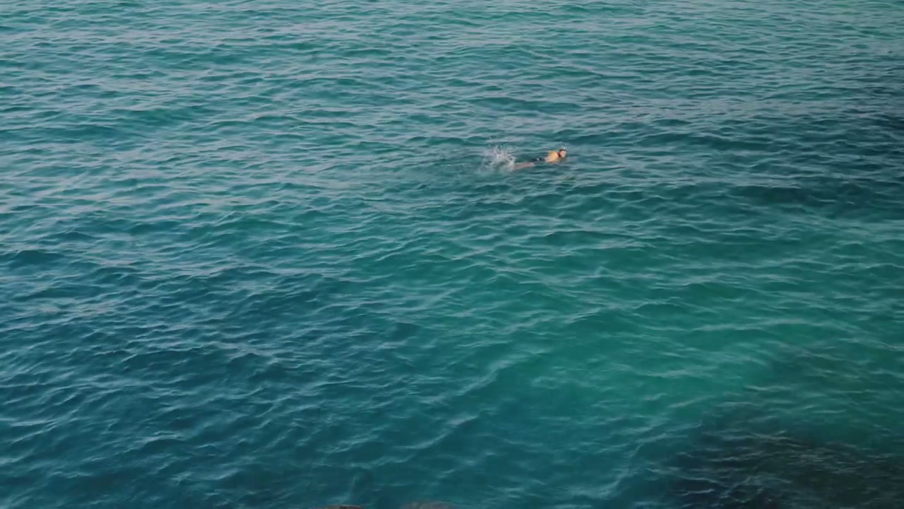 Man Swimming in Blue Ocean Water