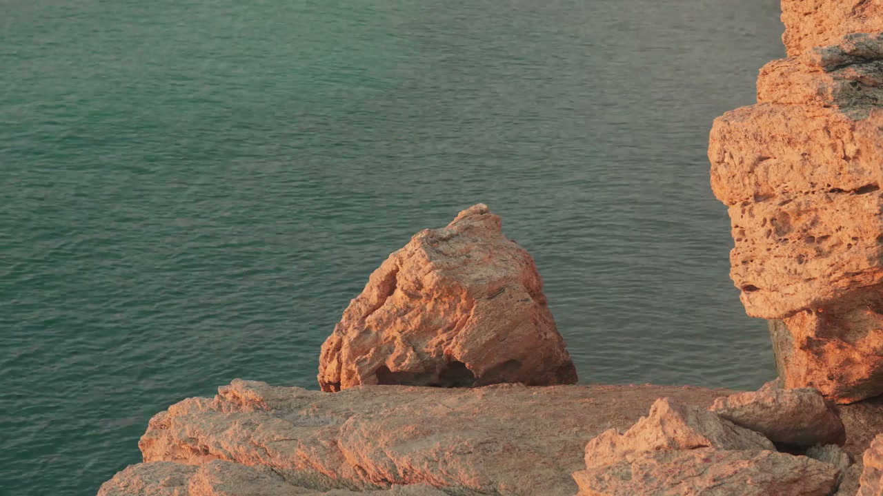 Golden Hour Coastal Rocks and Turquoise Sea