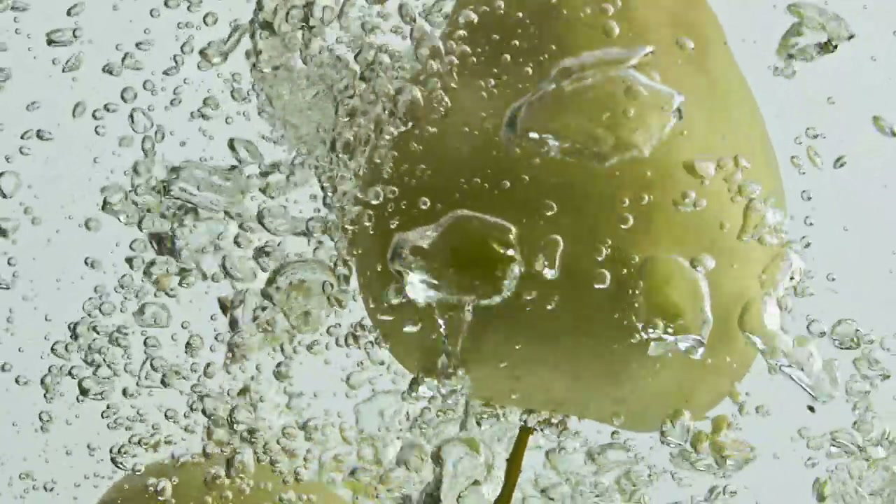Green Apples Splashing in Water