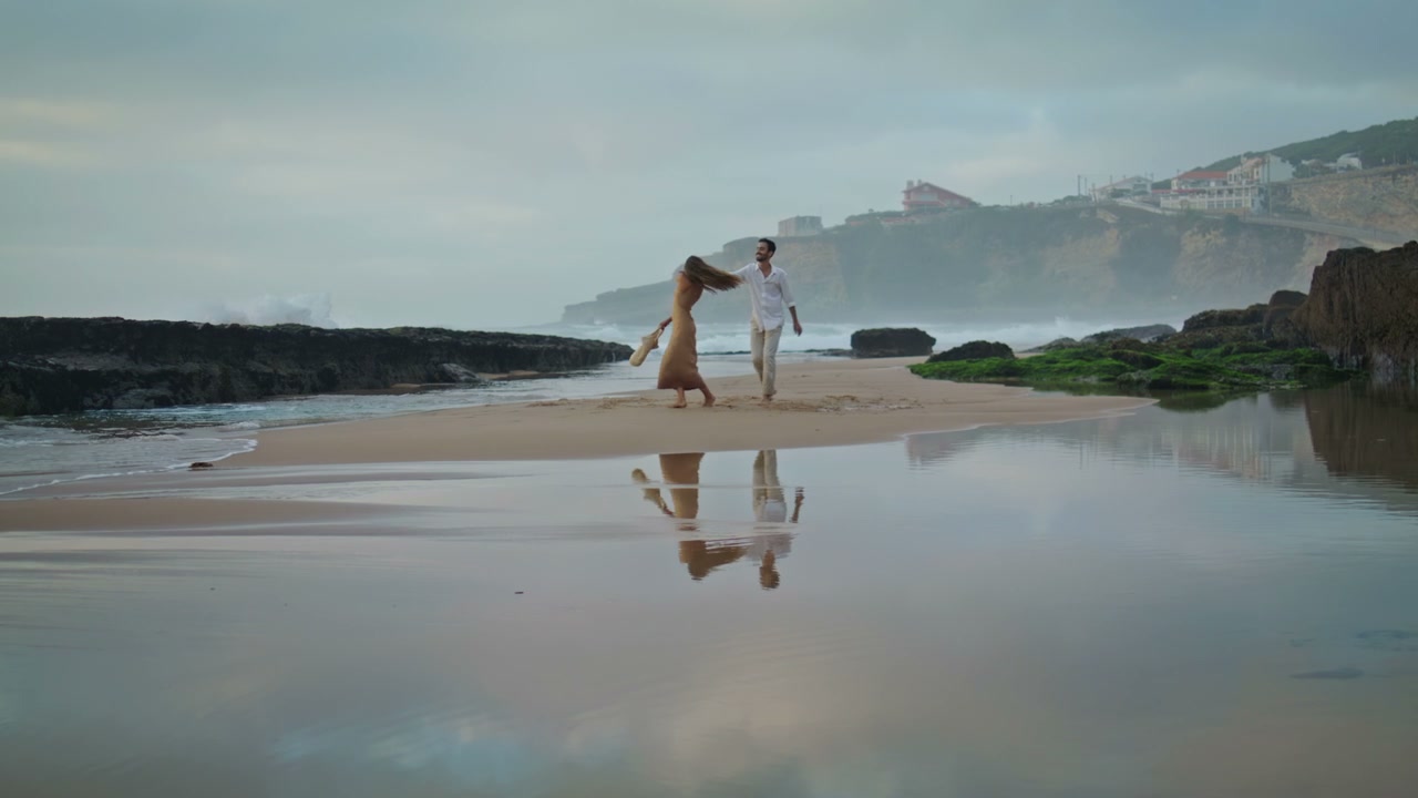 Couple Twirling on Misty Beach