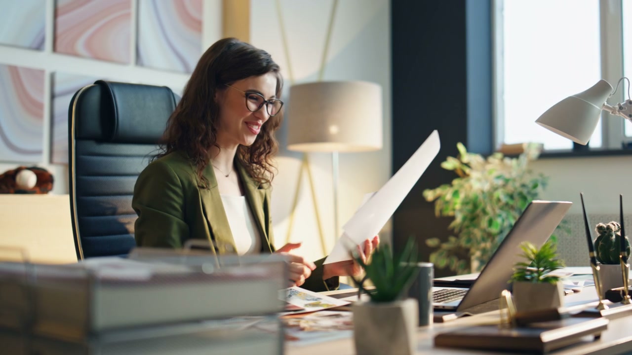 Smiling Businesswoman Reviewing Design Samples