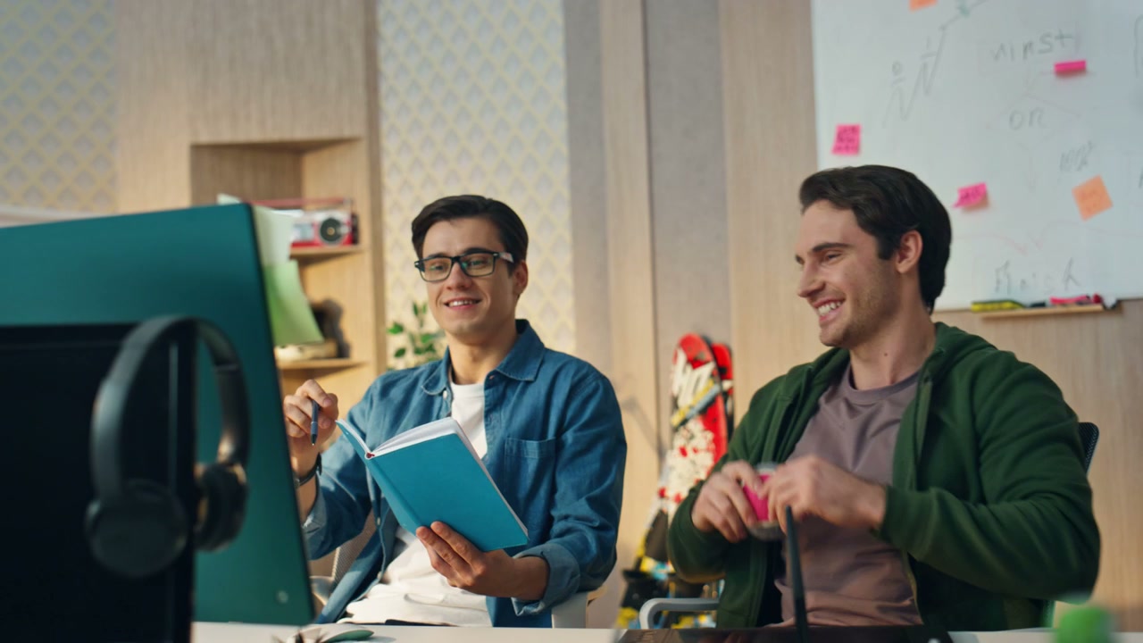 Cheerful Coworkers Working Together at Office Desk