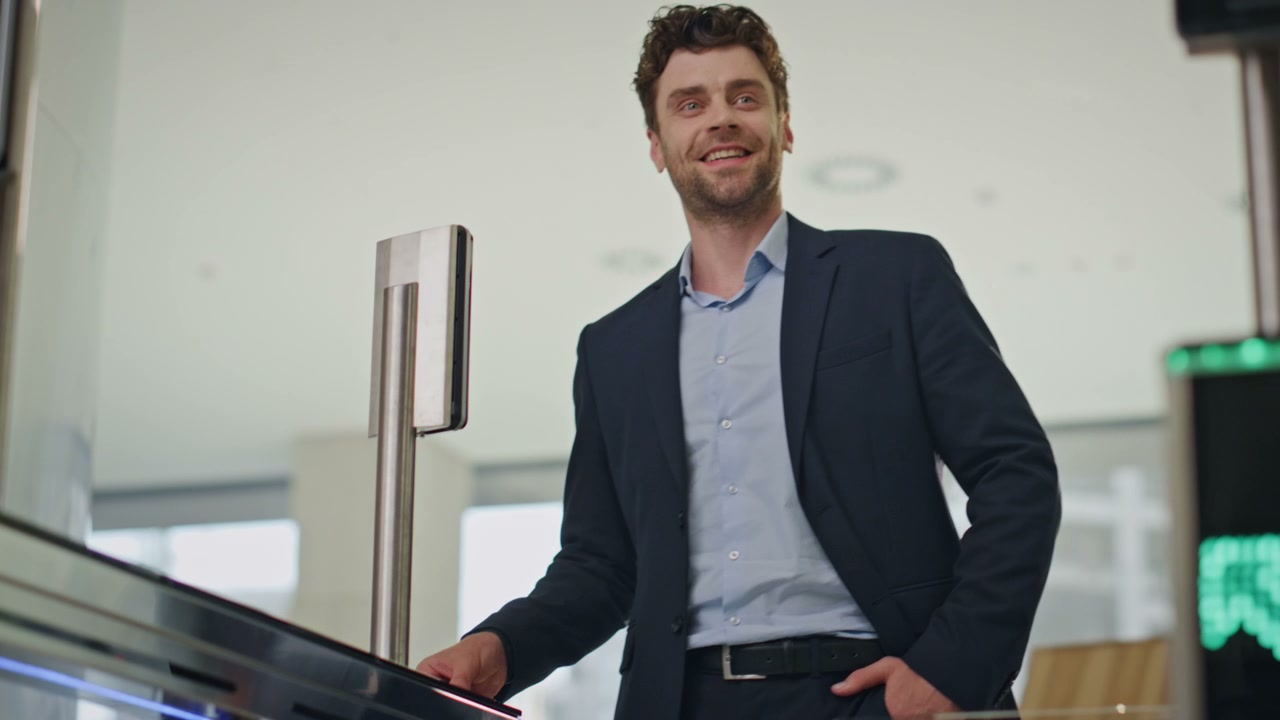 Businessman Swipes Keycard at Office Turnstile