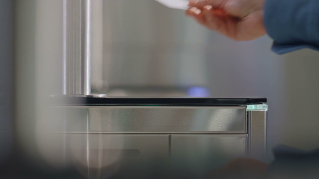 Hand Swiping Keycard at Security Sensor