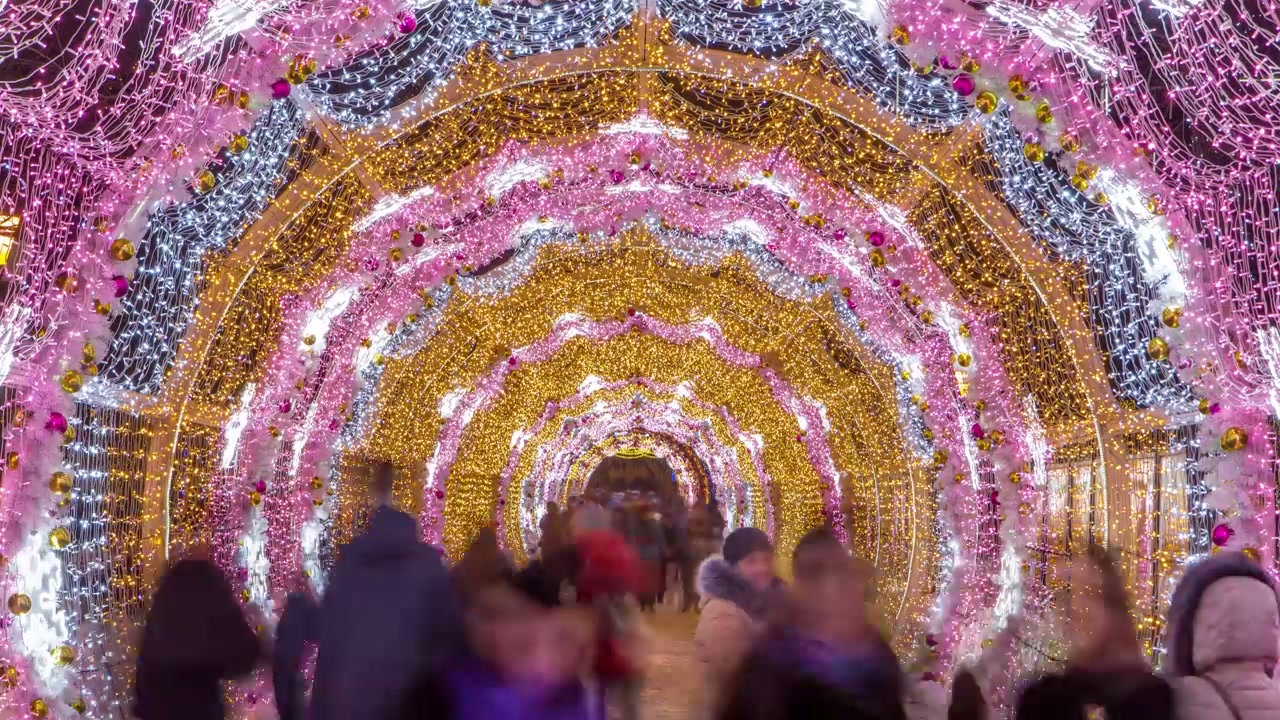 People Walk Through Festive Light Tunnel in Moscow