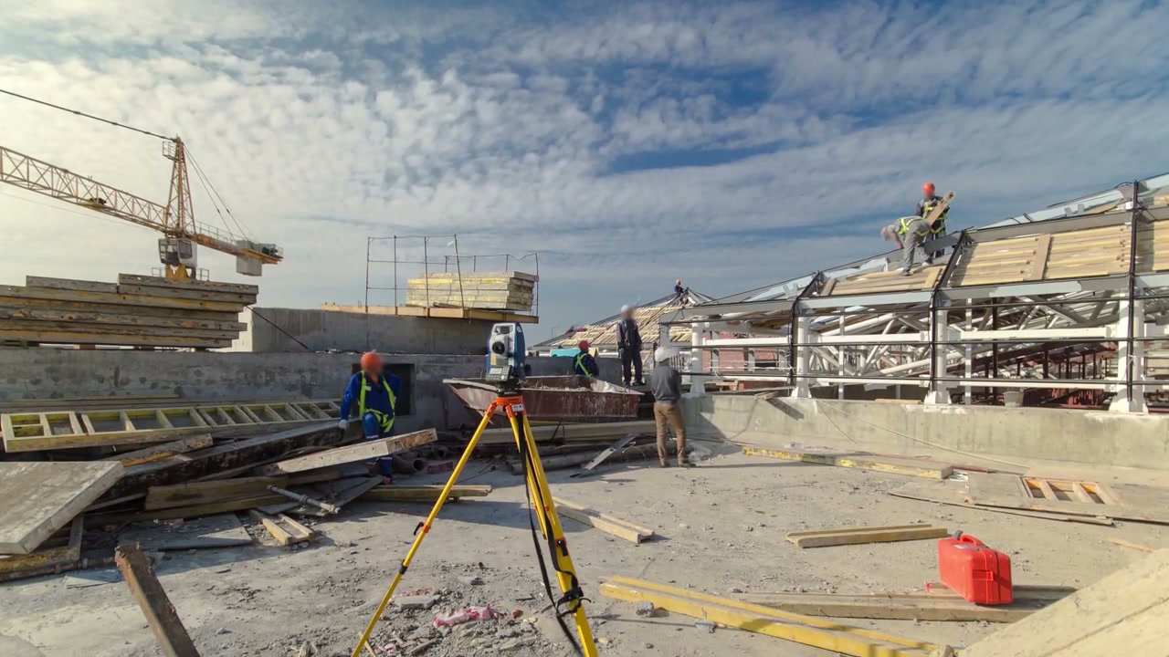 Construction Site with Surveyor and Workers