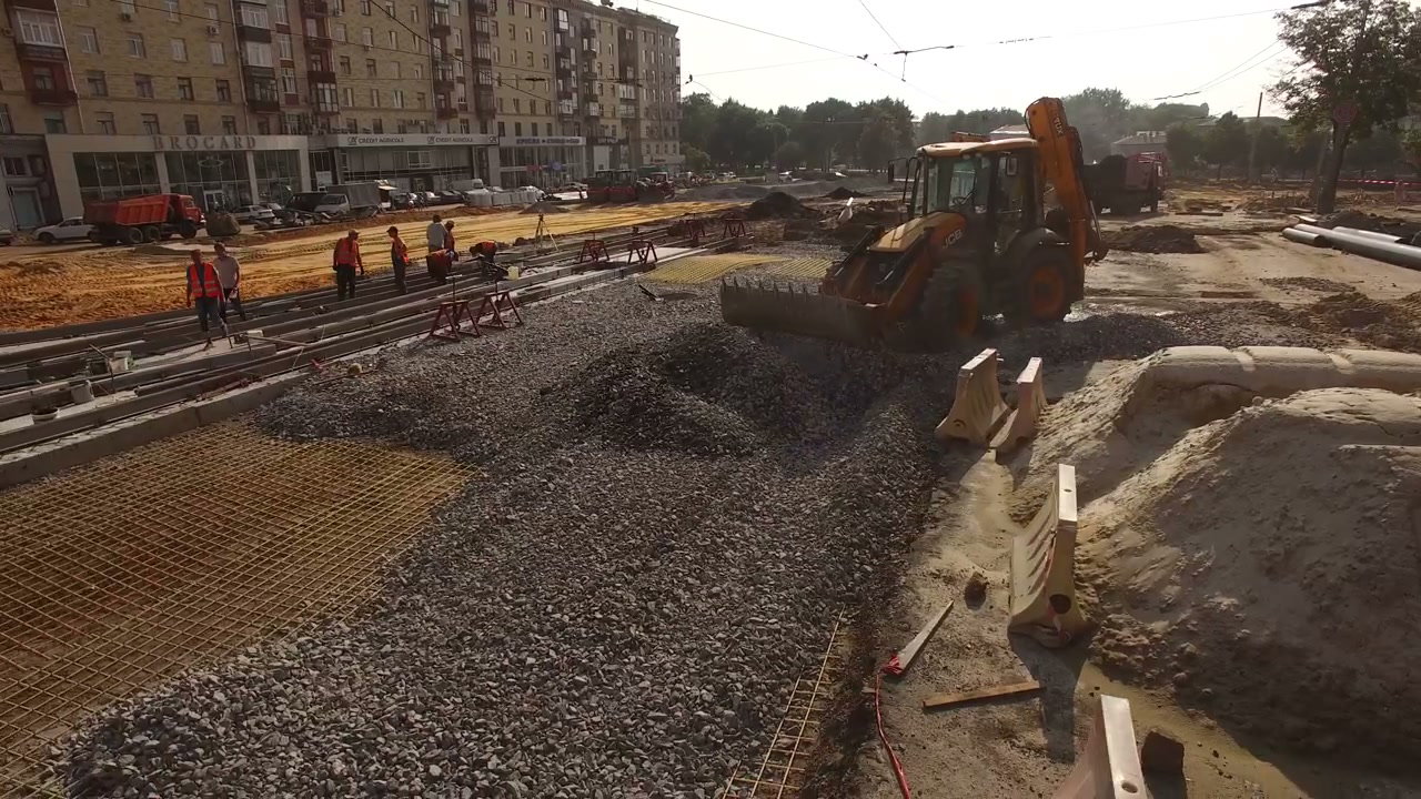 Workers and Excavator at Road Construction Site