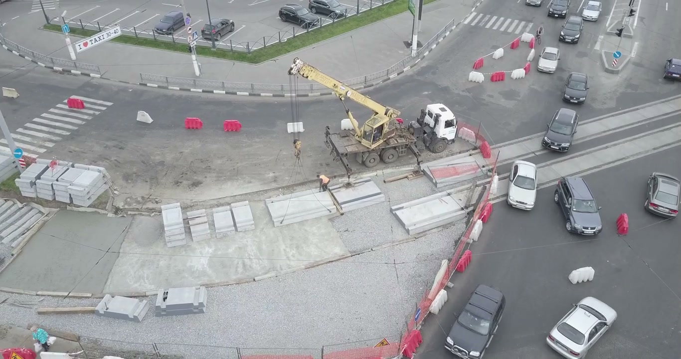 Construction Workers with Crane on City Road
