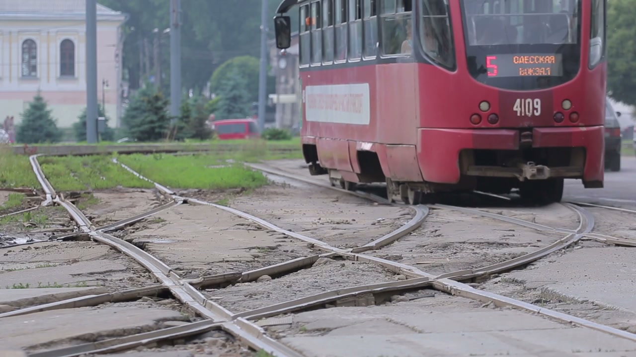 Red Tram Turning on City Tracks