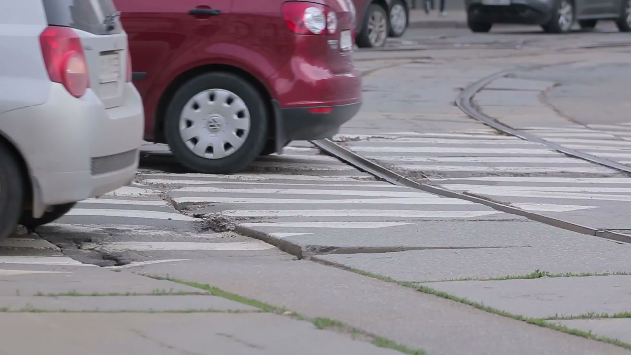 Traffic Crossing Tram Tracks on Urban Street