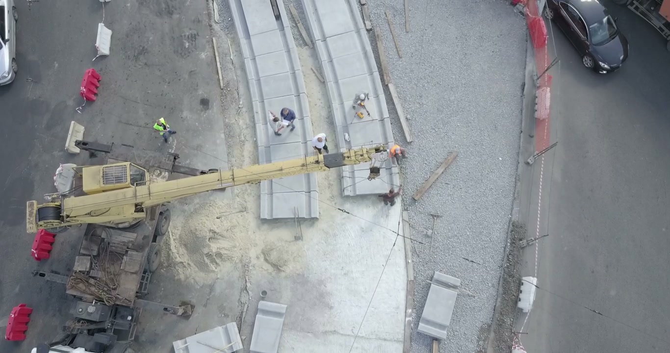 Crane Lifts Concrete Slabs for Tram Track