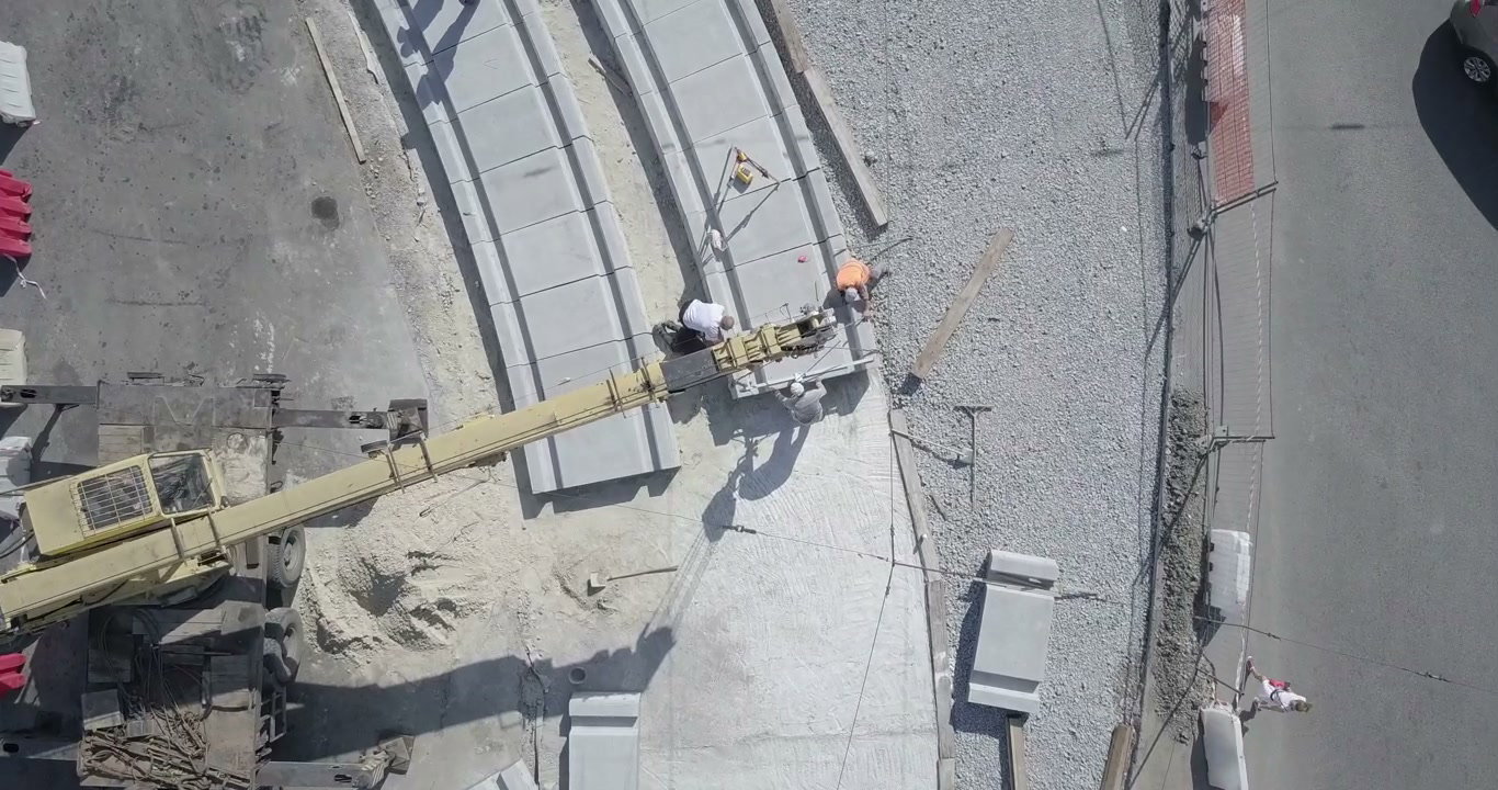 Construction Workers Laying Concrete Slabs
