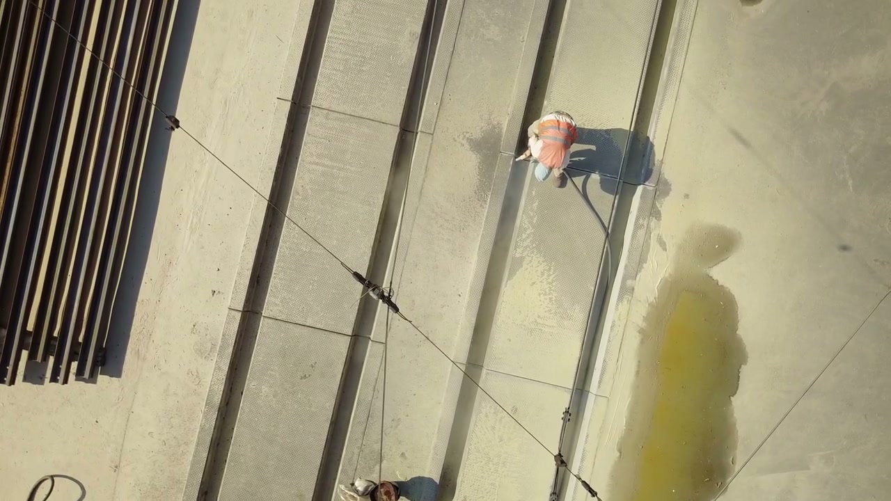 Construction Worker Cleaning Concrete Slabs Aerial