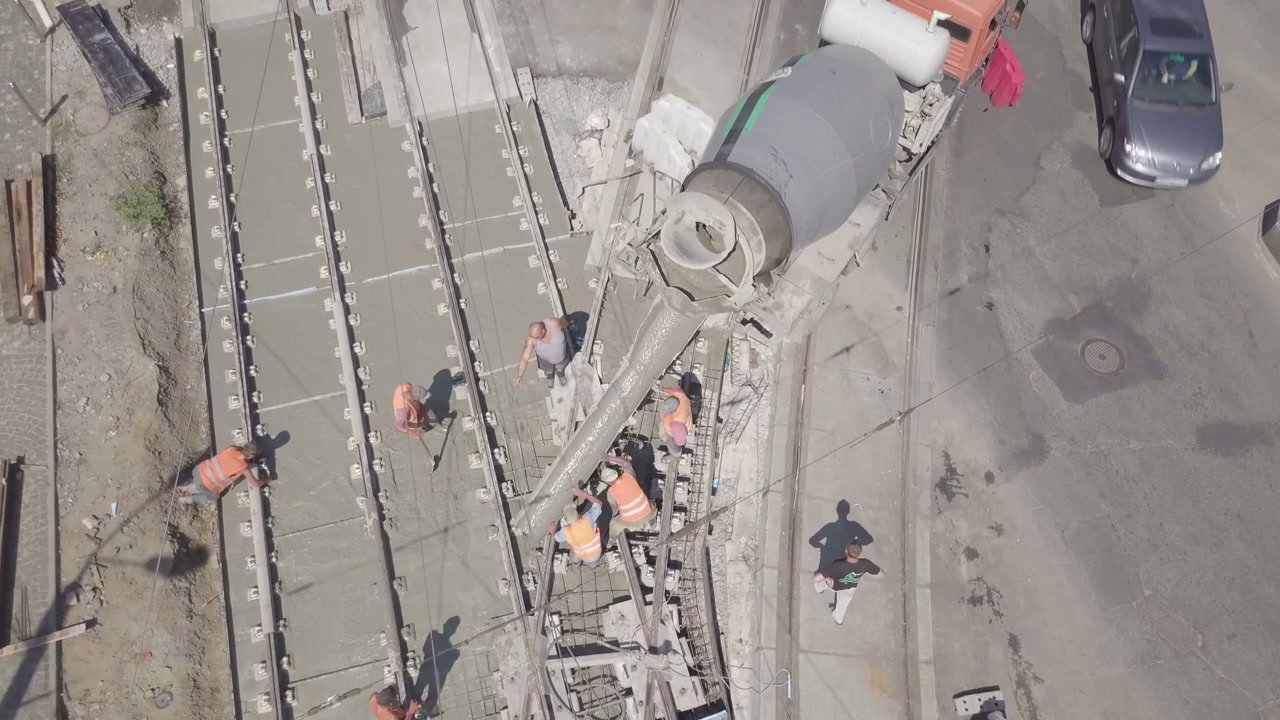 Aerial View Workers Pouring Concrete for Tram Tracks