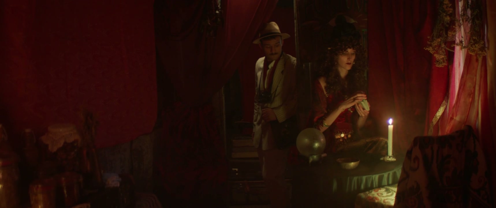 Man Observes Fortune Teller in Candlelight