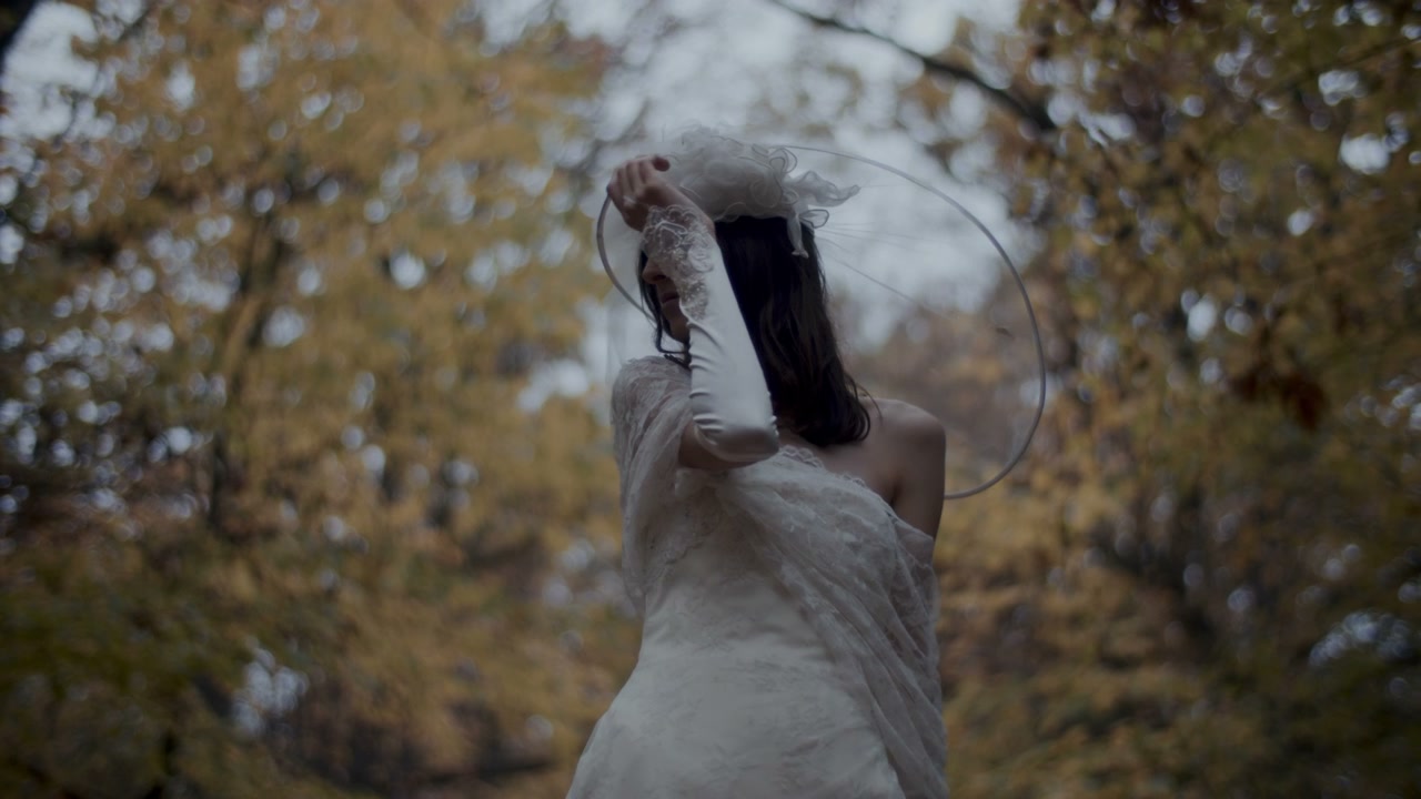 Woman in Wedding Dress Posing in Autumn Forest