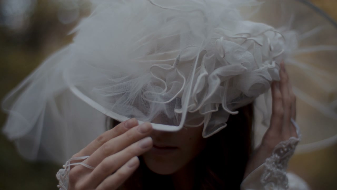 Woman Adjusting White Bridal Veil