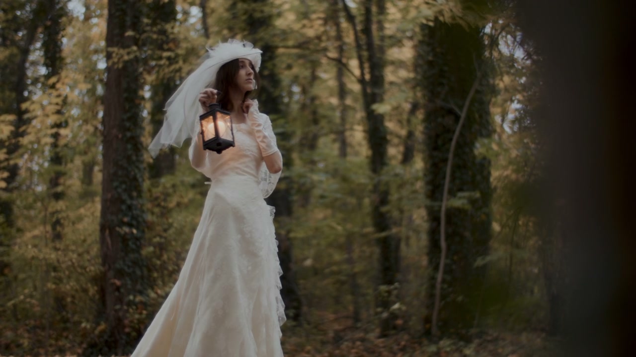 Woman in Wedding Dress Walking with Lantern