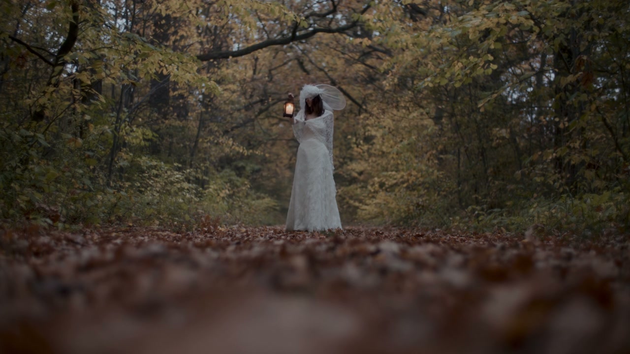 White Lady Holding Lantern in Forest