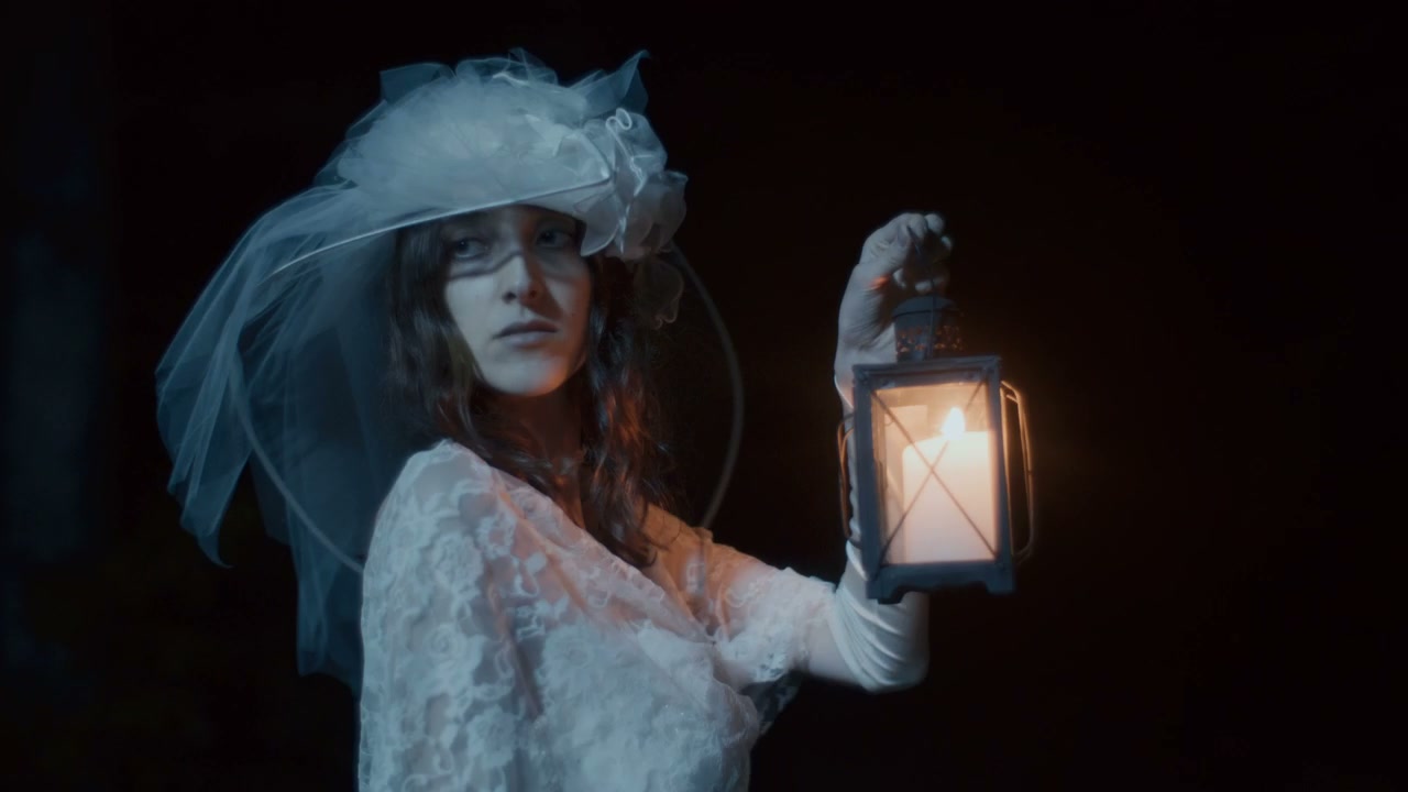 Woman in White Dress Holding Lantern