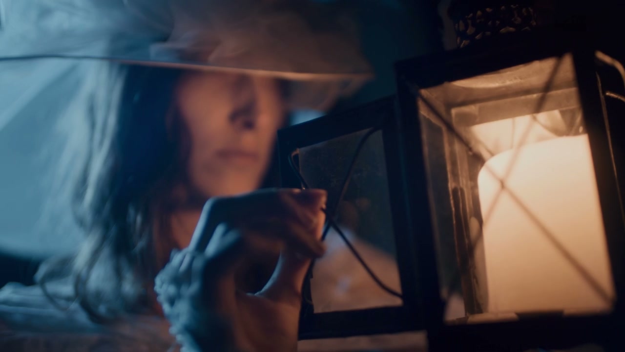 Woman Gazing into Candle Lantern