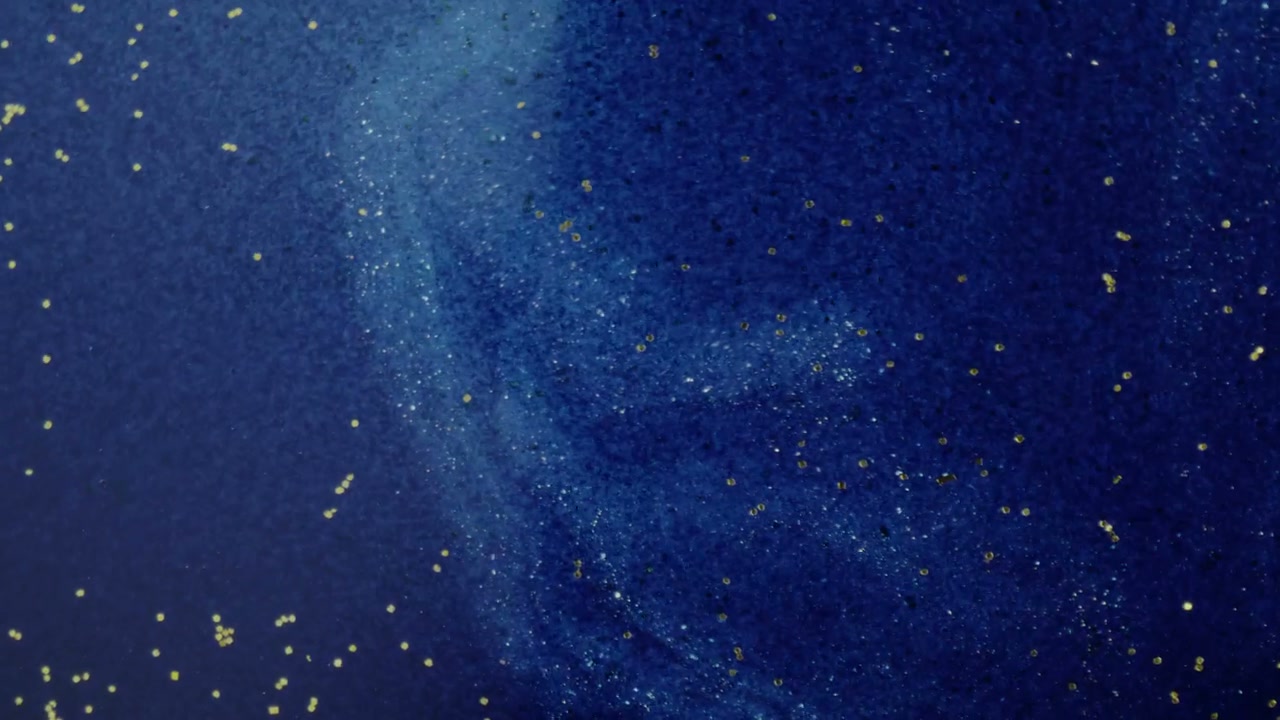 Swirling Blue Liquid with Gold Particles