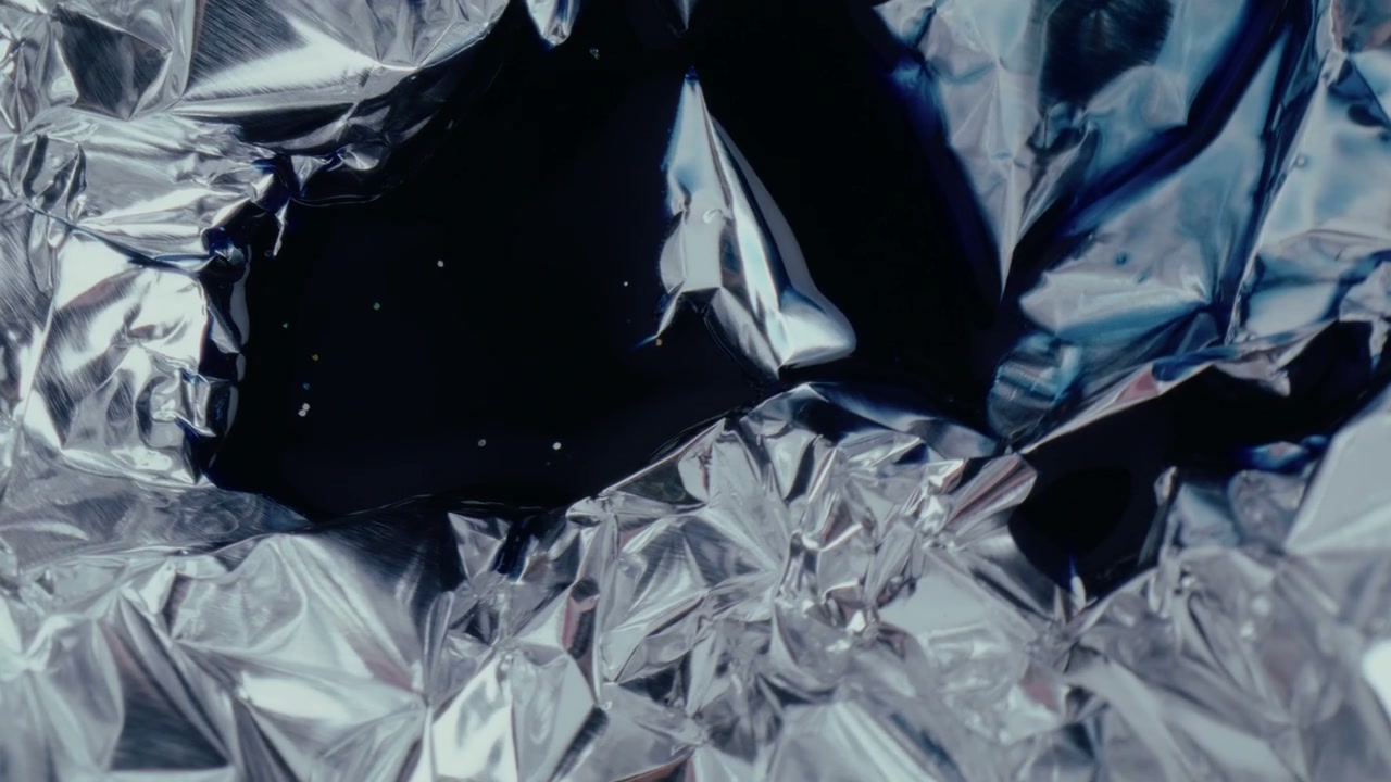 Abstract Silver Foil and Dark Liquid