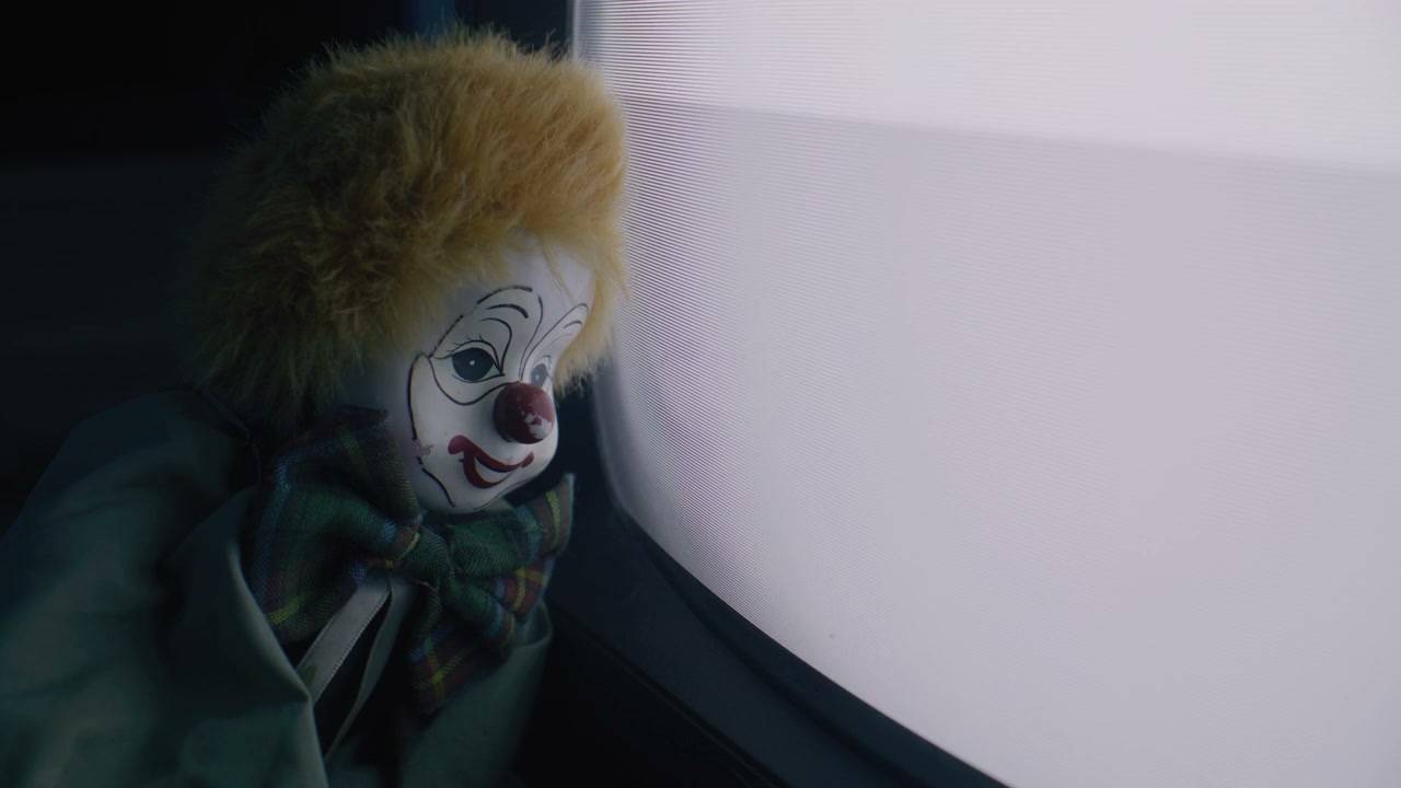 Vintage Clown Doll Watching Old TV Screen