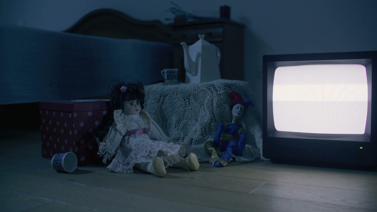 Vintage Dolls and Static TV in Dark Room