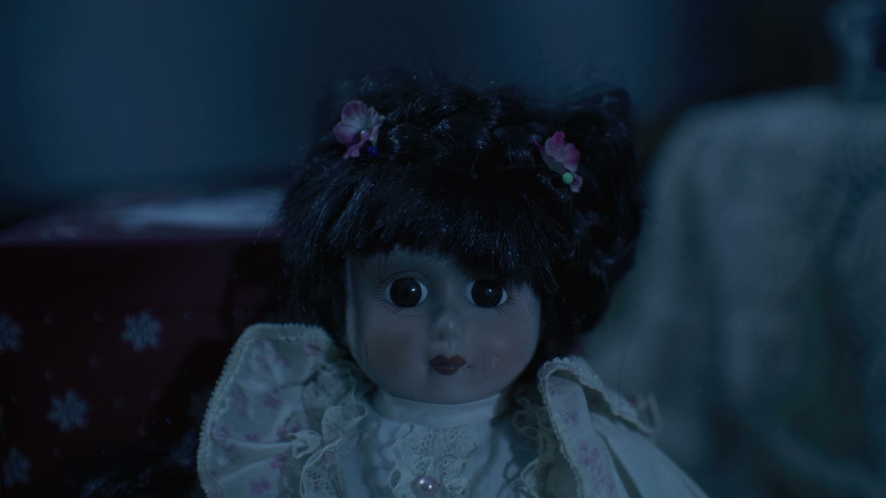 Creepy Porcelain Doll in Dark Room