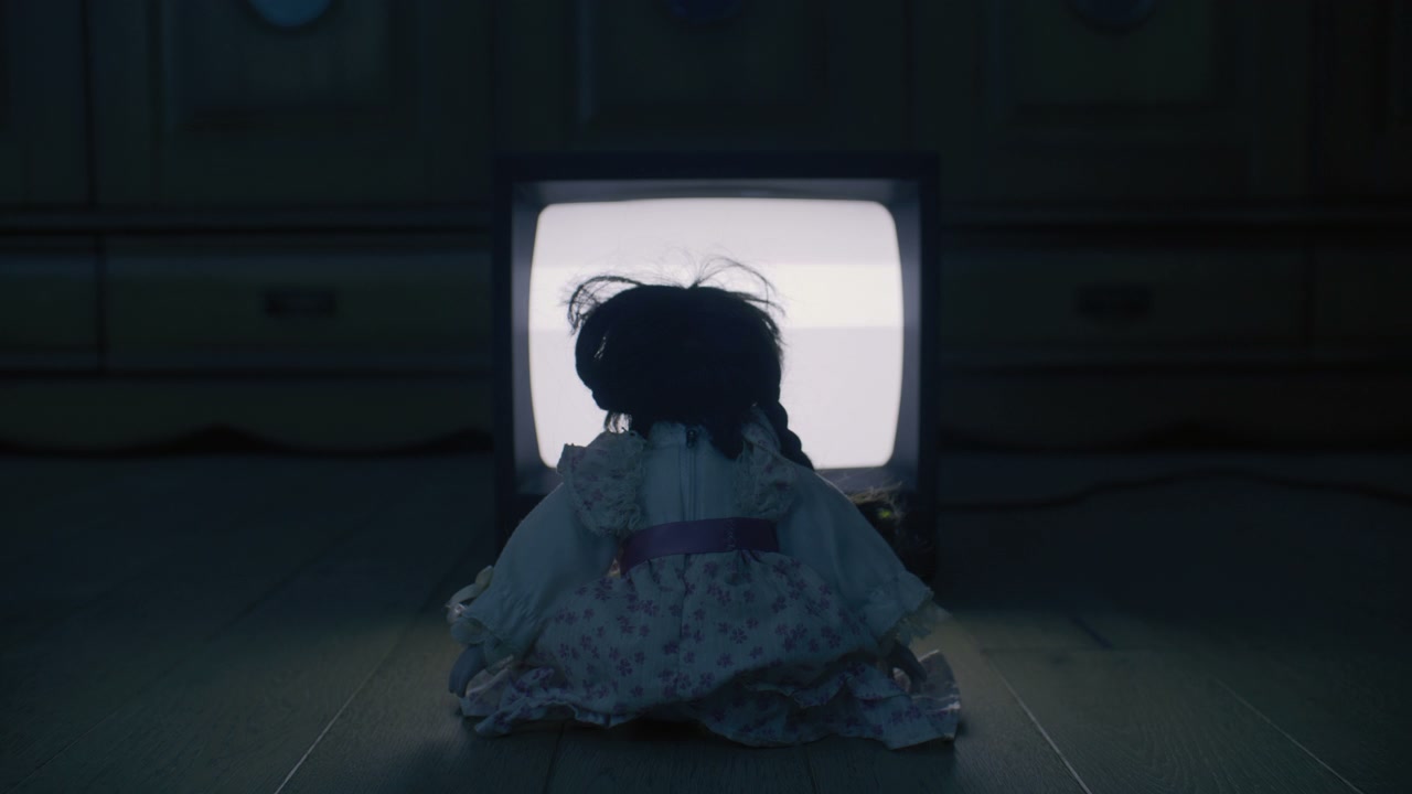 Creepy Doll Watching Static Television
