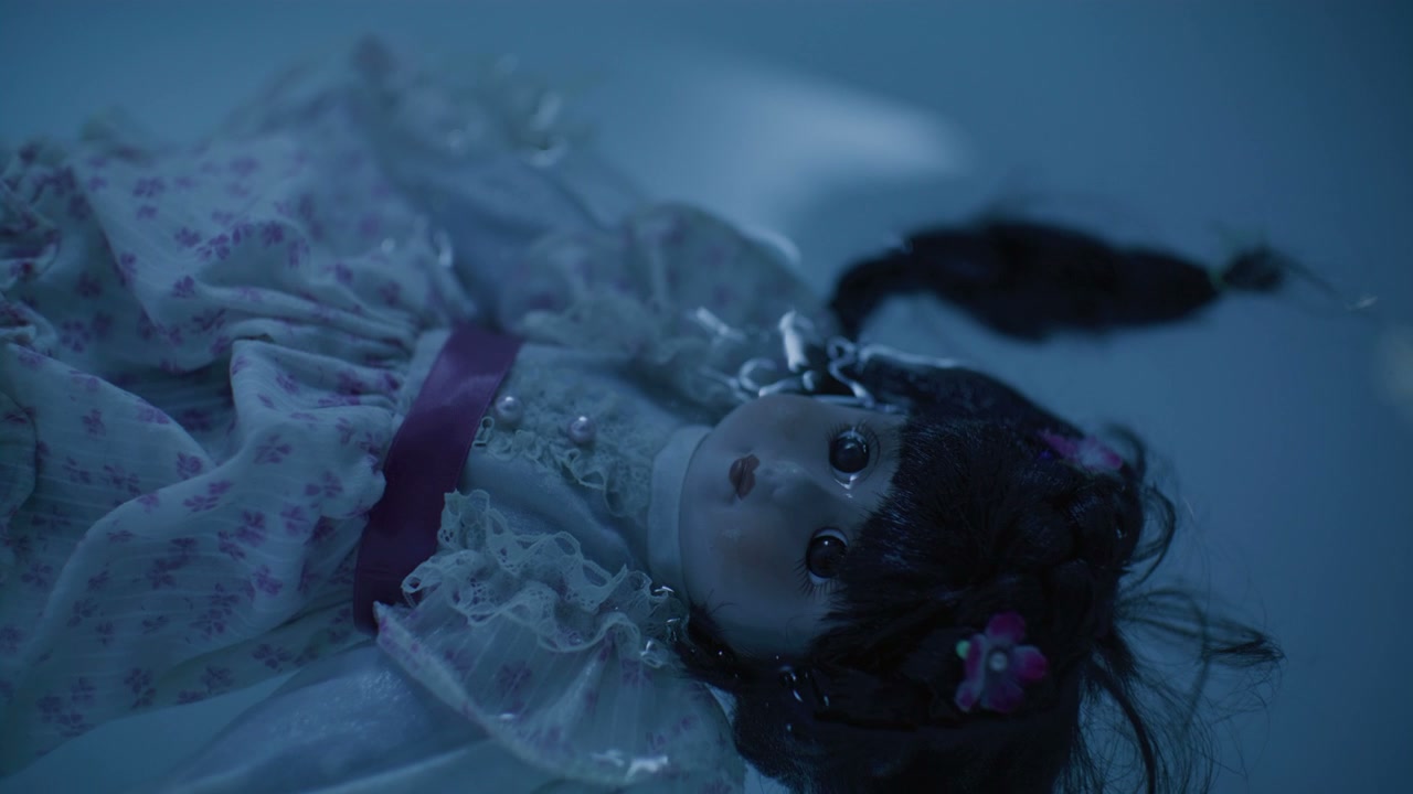 Eerie Doll Floating in Water
