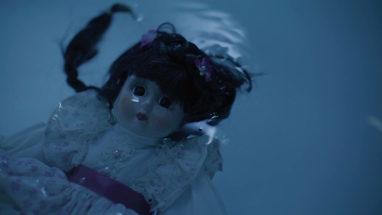 Eerie Porcelain Doll Floating in Dark Water