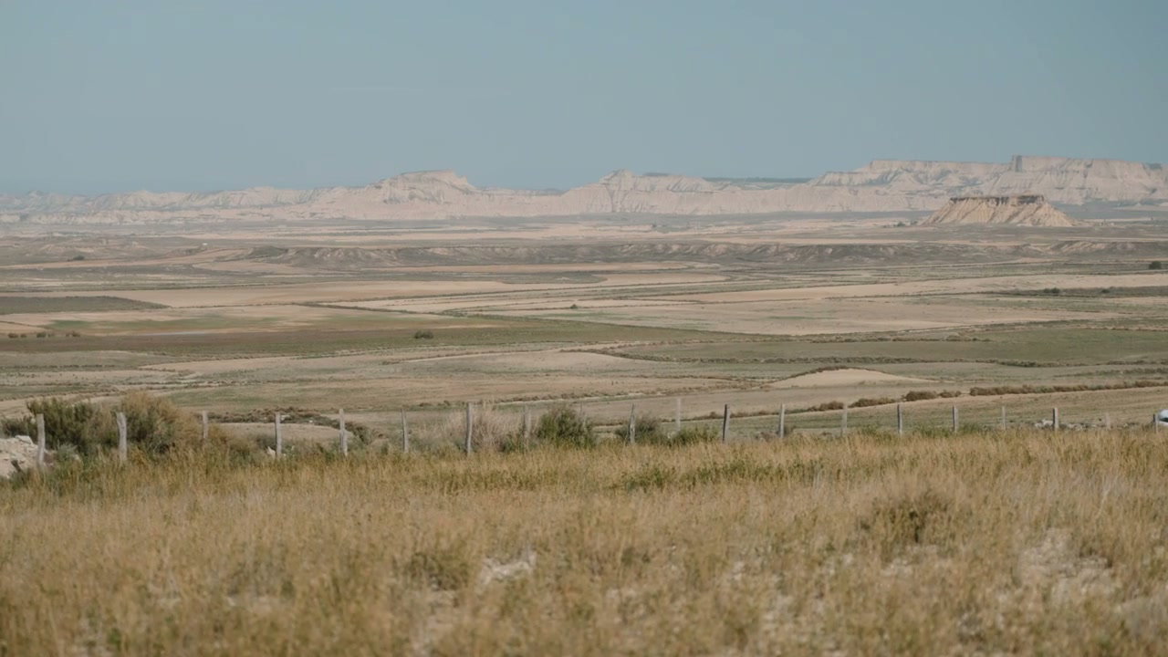 White Van Driving Through Arid Spanish Landscape